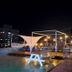 Pohang Youngildae Guesthouse rooftop terrace with picnic tables and city lights in Pohang