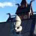 Hotel Viking in Hafnarfjordur with a Viking-style building, horned roof details, and statue in front