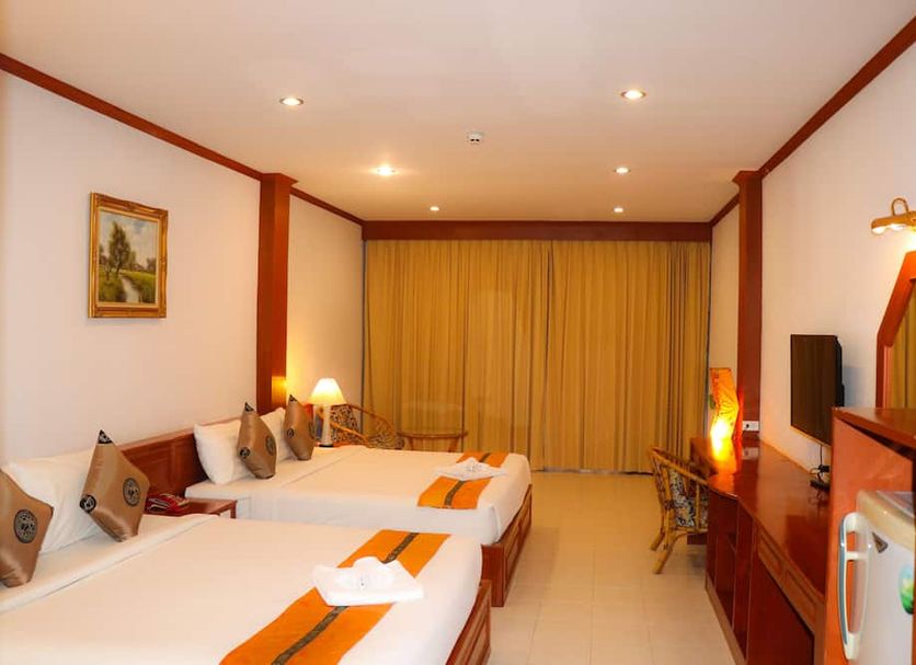 Andaman Seaside Resort in Choeng Thale guest room with two twin beds and warm lighting