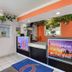 Motel 6 King City CA lobby front desk with orange accents and potted plants