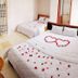 Ban Mai Hotel 66 in Phan Thiet room with two beds decorated with rose petals and flowers