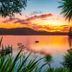Bay of Many Coves in Picton with sunset over a calm bay, small dock, and lush shoreline