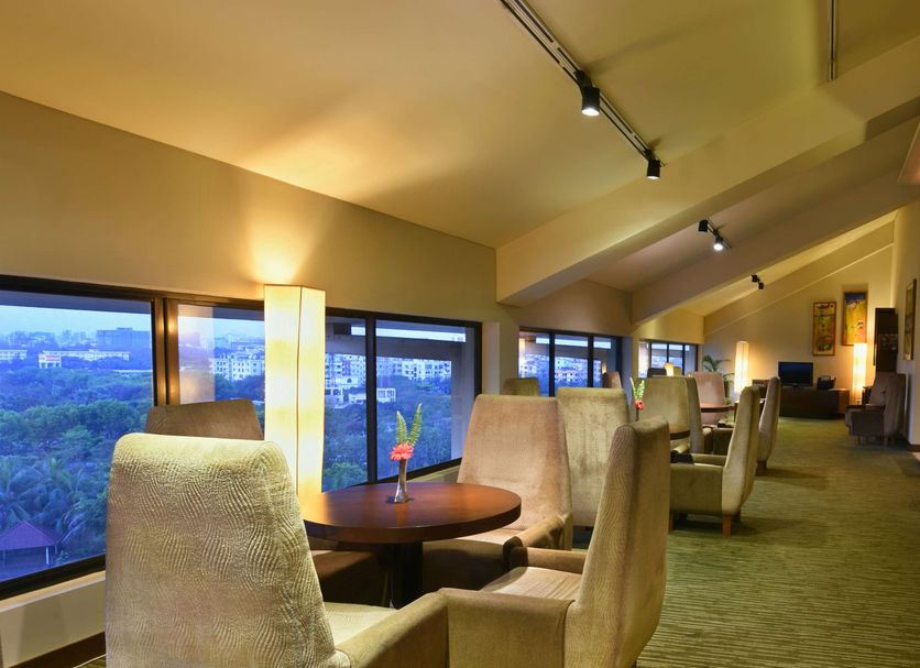 Radisson Blu Dhaka Water Garden lounge with city views and upholstered chairs in Dhaka