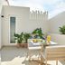 Room Mate Collection Helen Berger in Valencia patio with dining table, potted plants and sliding glass doors