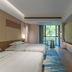 Tian Xing Hotel Chongqing guest room with twin beds, wall TV, and balcony view
