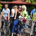 Grand Crown Hotel in Anuradhapura guests on bicycles outdoors near a red-roofed building