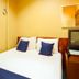 Casavilla Travellers Lodge Pudu in Kuala Lumpur room with bed, TV, and wall mirror