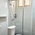 The Goose House Ubon bathroom with sink, toilet and glass shower in Ubon Ratchathani