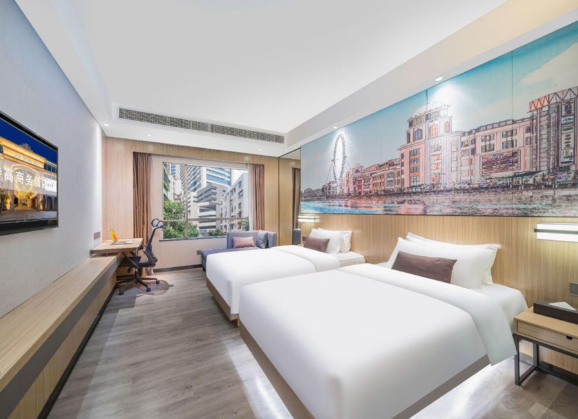 Zhongshan Tegao Business Hotel room with twin beds and city mural in Zhongshan