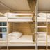 Guanwu Villa in Tai'an Township bunk beds with white bedding and gold curtains in a shared dorm room