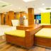 Citihub Hotel @Pecindilan Surabaya lobby with yellow seating and wood reception area, Surabaya