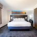 Independence Stay Hotel and Long term suites in Houghton guest room with king bed, large window and desk