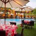 The Arnawa Hotel, Pangandaran: courtyard pool with umbrellas and outdoor dining tables
