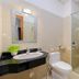 Queen Garden Hotel & Apartment Vung Tau bathroom with sink, toilet and glass-enclosed shower