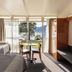 Riverfront Motel & Restaurant, Berriedale room with lake view, table by window, and single beds