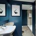 Portsmouth Marriott Hotel bathroom with sink, wall art, glass shower, and beige tiled walls in Portsmouth