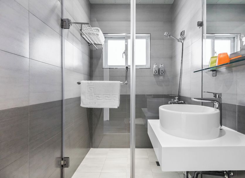 Fairyland & Farm Guest House bathroom in Hengchun Township with glass shower, wall-mounted sink and towel rack