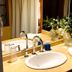Hosteria La Raclette bathroom sink vanity in San Martín de los Andes with mirror and flowers