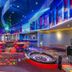 Royalton CHIC Punta Cana casino lounge with roulette table, red seating and colorful neon lighting