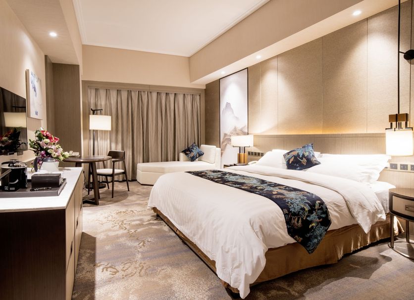 Jin Jiang Pine City Hotel Shanghai guest room with two beds, desk, TV, and window seating