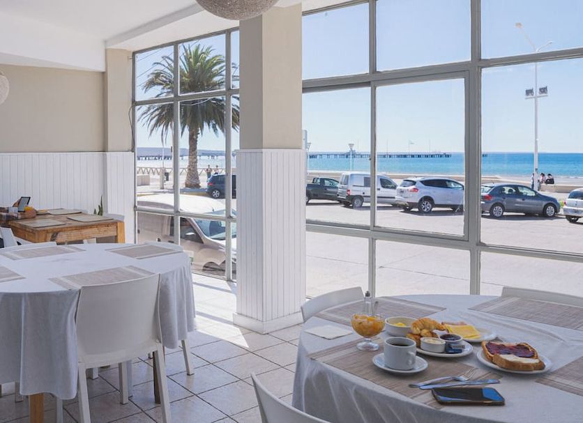 Rayentray Hostal in Puerto Madryn dining room with ocean view and large windows