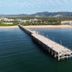 Matador Motor Inn in Coffs Harbour with a long pier over calm blue water and sailboats nearby
