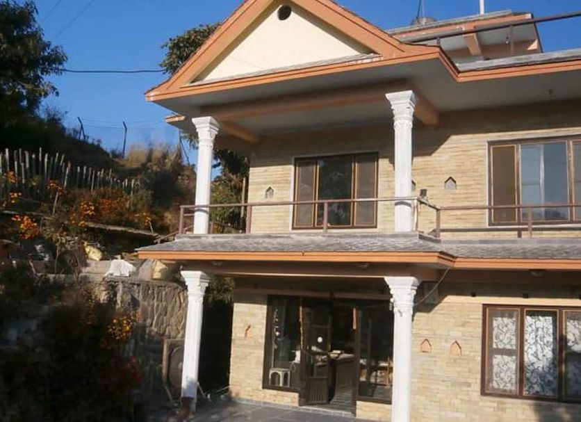 Tushita Nepal Yoga Retreat Center in Pokhara, two-story retreat building with balcony and mountain views