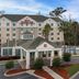 Hilton Garden Inn Tallahassee Central exterior with entrance, palm trees and outdoor pool in Tallahassee