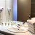Ours Blanc Victor Hugo Toulouse bathroom sink with wall-mounted hair dryers and stacked towels