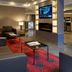 Residence Inn by Marriott Montreal Downtown lobby with sofas, red patterned rug, and wall-mounted TV