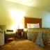 Airport Inn Downtown Phoenix guest room with bed, armchair, lamp and carpet