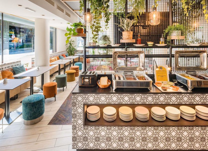 Ibis Styles Wien City breakfast buffet area with colorful seating in Vienna