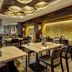 Cascada Boutique Hotel Lucerne restaurant with wooden tables, chairs and warm modern lighting