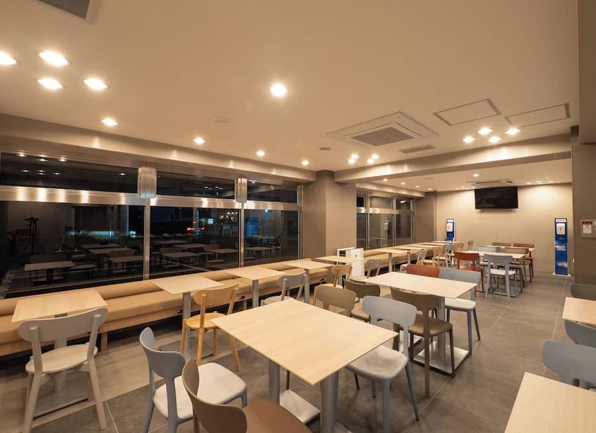Toyoko Inn Koriyama breakfast area with tables and chairs in Kōriyama