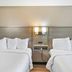 Red Roof Inn & Suites Fayetteville-Fort Bragg room with two double beds and bedside lights