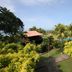 Gem Beach Resort in Kuala Terengganu with lush gardens, palm trees, and a glimpse of the sea