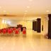 Hotel The Great Ananda, Haridwar conference hall with rows of red chairs and polished floor