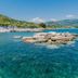 Hotel Torre Oliva in San Giovanni a Piro with clear turquoise sea, rocky shoreline and beach loungers