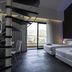 A Point Porto Ercole Resort & Spa room with spiral staircase, twin beds and balcony view in Porto Ercole