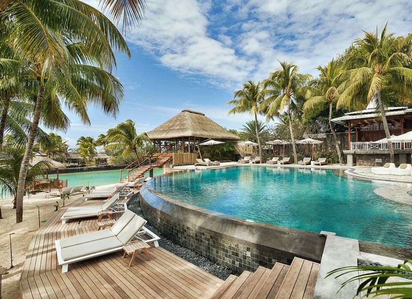 Paradise Cove Boutique Hotel in Cap Malheureux with a curved infinity pool, loungers and palm trees