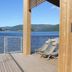 Nisser Hyttegrend Og Camping in Treungen: lakeside deck with lounge chairs and mountain views