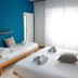 HC Resort room in Lignano Sabbiadoro with double bed, single bed, and bright window