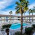Motel 6 El Centro pool courtyard with palm trees and a two-story exterior in El Centro