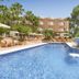 allsun Hotel Paguera Vera Beach in Peguera with outdoor pool, waterfall feature and palm trees