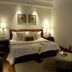 Ananda in the Himalayas, Rishikesh: cozy bedroom with king bed, bedside lamps, and armchair