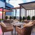 Sathyam Oasis, Tiruchirappalli: rooftop terrace dining area with seating, pergola shade and city view