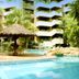 Yotau All Suites Hotel in Santa Cruz de la Sierra with palm-lined pool and thatched poolside bar