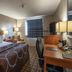 Super 8 by Wyndham Miles City guest room with king bed, desk, chair and window blinds