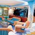 Oasi Azzurra in Villafranca Tirrena lounge with wicker seating and colorful marine decor