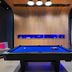 Aloft Waco Downtown game room with blue pool table and lounge seating in Waco